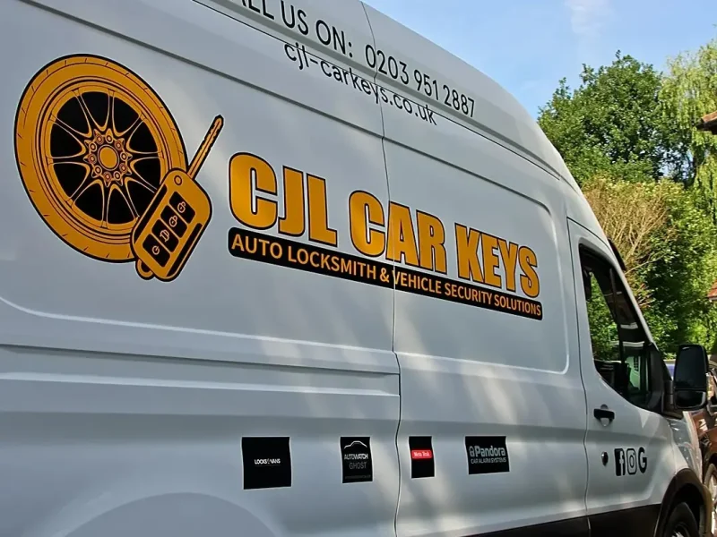 Close-up of the CJL Car Keys logo and phone number on the side of the van